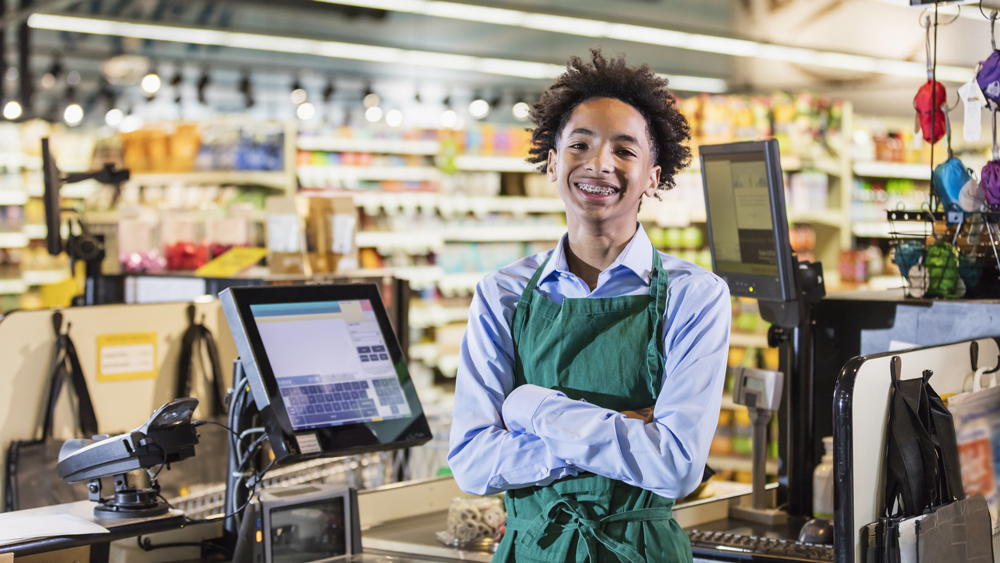 young cashier at grocery store