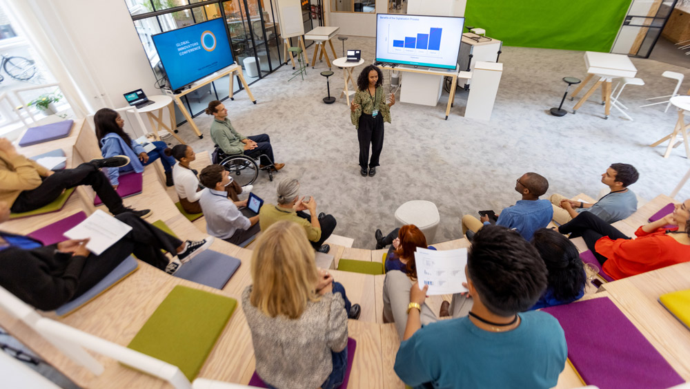 woman presenting to a group of business professionals