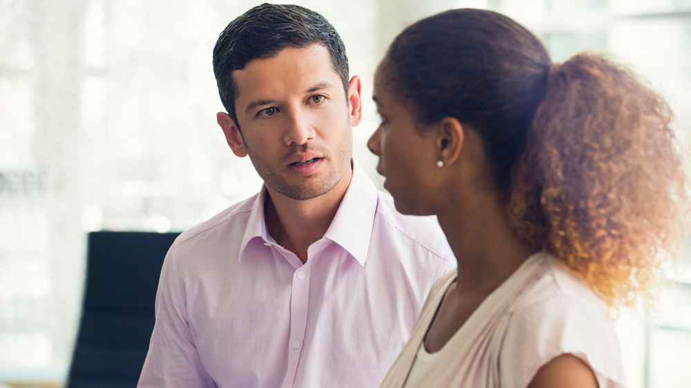 man and woman colleagues talking to each other