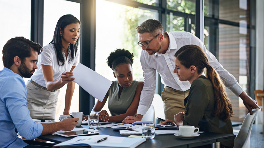 team of professionals sharing ideas in boardroom