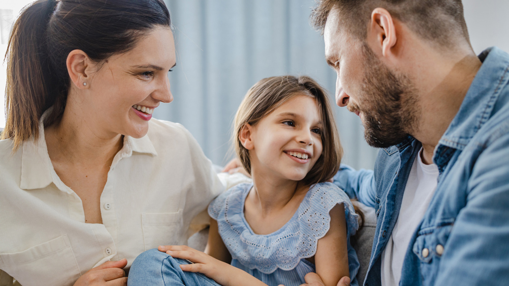 mom, dad, and daughter at home