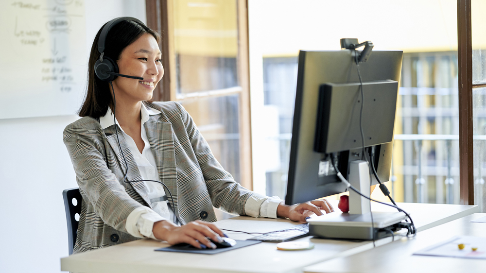 telemarketer workin in office with by the window
