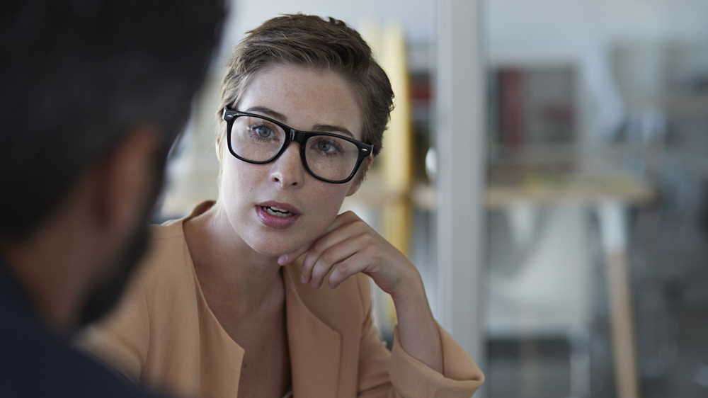 man and woman talking at work