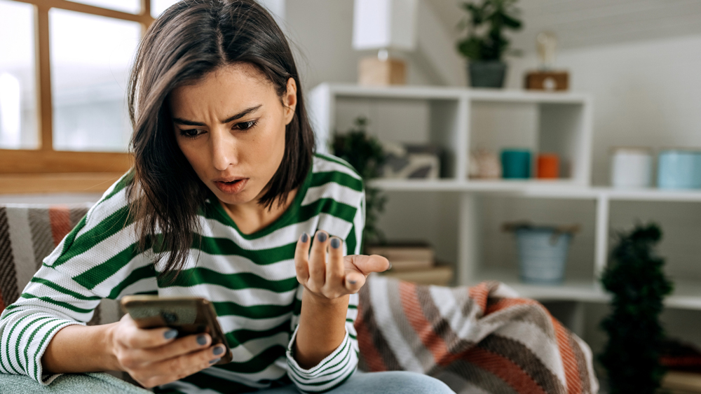 worried young woman on smartphone