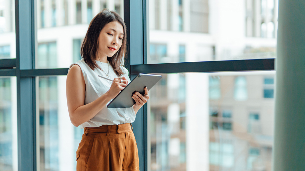 Young business woman using digital tablet
