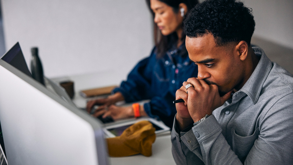 worried man sitting at desktop computer