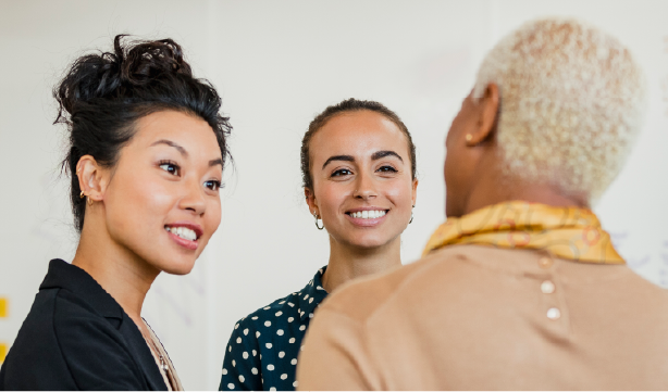 Three woman coworkers conversing