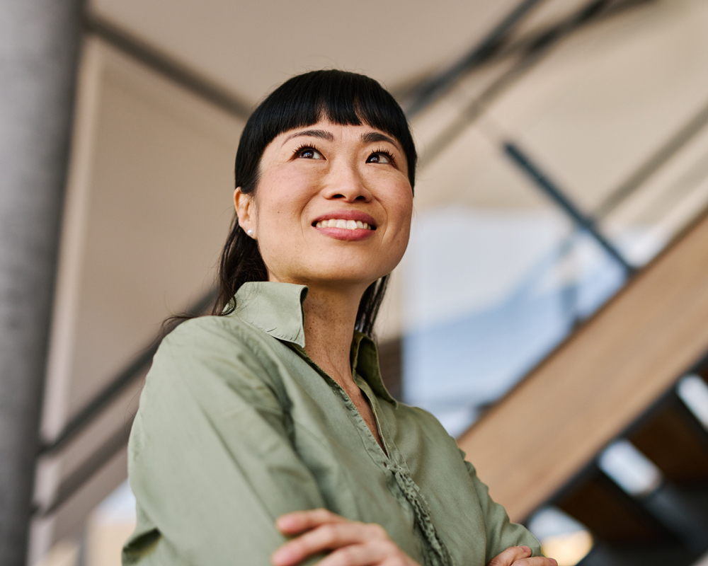 Confident Businesswoman Smiling in Modern Office Building
